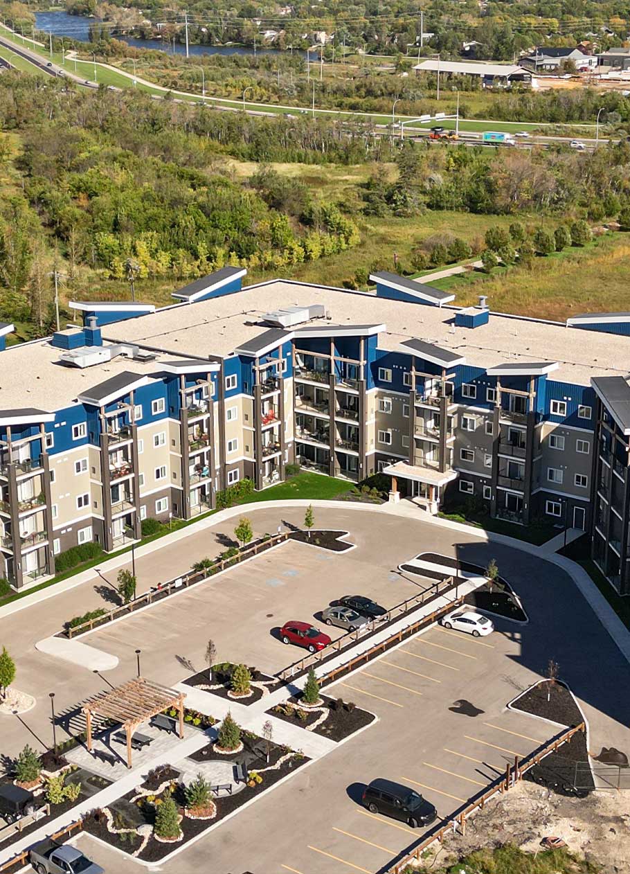 Exterior drone shot of a multi-storey condo building. 